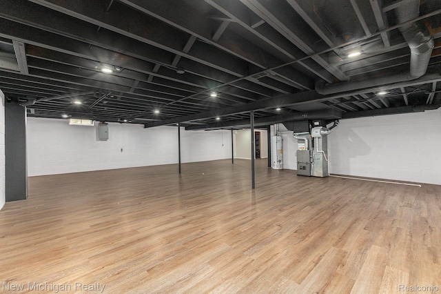 23306 Greencrest St, Saint Clair Shores, MI 48080 - finished basement with heating unit, wood finished floors, electric panel, and gas water heater