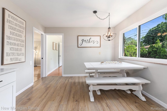 23306 Greencrest St, Saint Clair Shores, MI 48080 - dining room featuring light wood finished floors and a chandelier