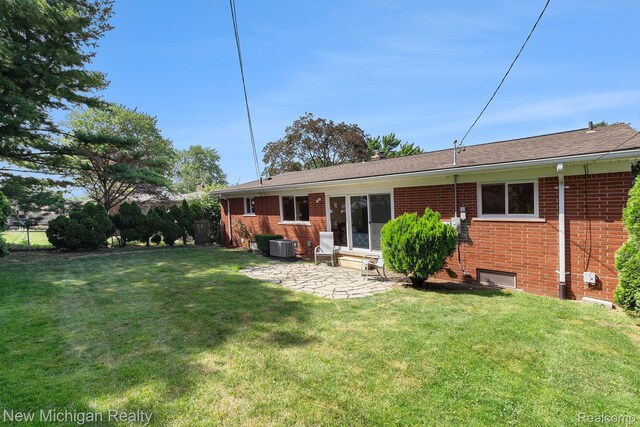 23306 Greencrest St, Saint Clair Shores, MI 48080 - rear view of property featuring brick siding and a patio area