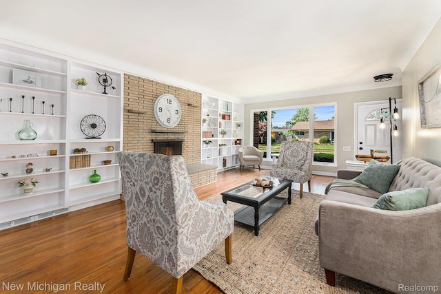 23306 Greencrest St, Saint Clair Shores, MI 48080 - living room featuring wood finished floors, built in shelves, and a fireplace