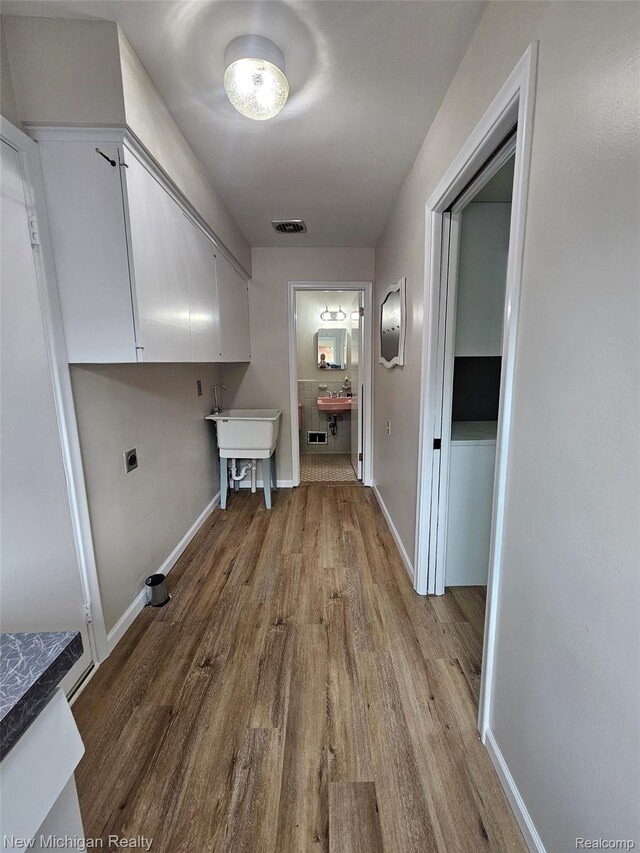 23306 Greencrest St, Saint Clair Shores, MI 48080 - laundry room featuring cabinet space, wood finished floors, and hookup for an electric dryer
