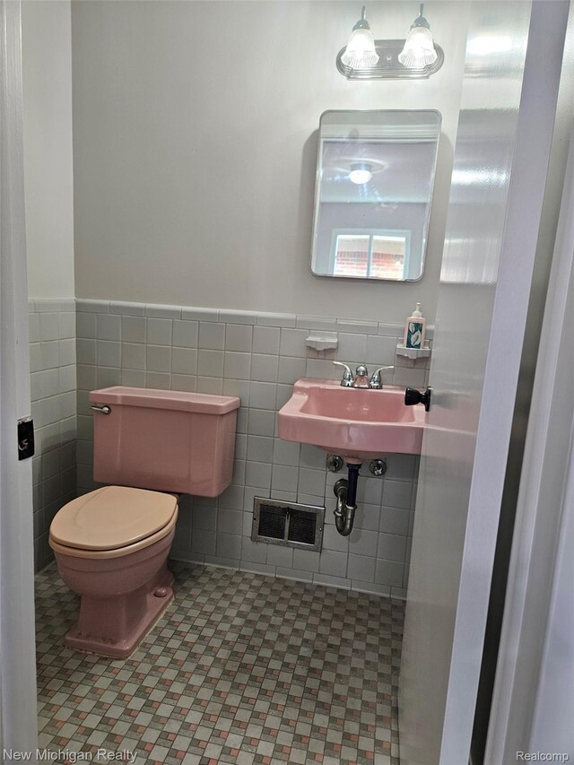 23306 Greencrest St, Saint Clair Shores, MI 48080 - half bathroom featuring wainscoting, tile walls, and tile patterned floors