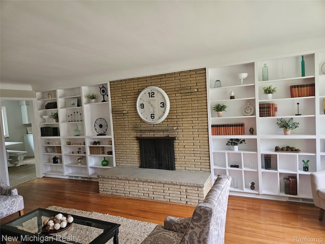 23306 Greencrest St, Saint Clair Shores, MI 48080 - living room featuring wood finished floors and a brick fireplace