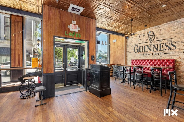 139 Pearl St NW, Grand Rapids, MI 49503 - interior space with an ornate ceiling, brick wall, and wooden walls