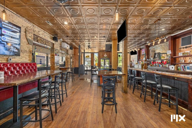 139 Pearl St NW, Grand Rapids, MI 49503 - indoor dry bar featuring an ornate ceiling, wood finished floors, and brick wall