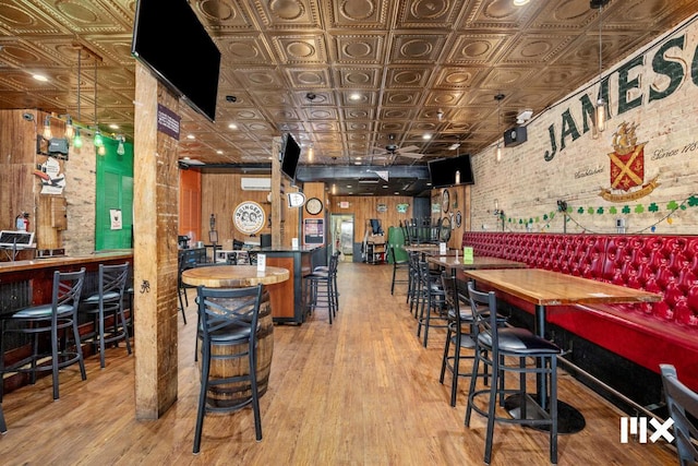 139 Pearl St NW, Grand Rapids, MI 49503 - bar featuring an ornate ceiling, wood finished floors, and brick wall