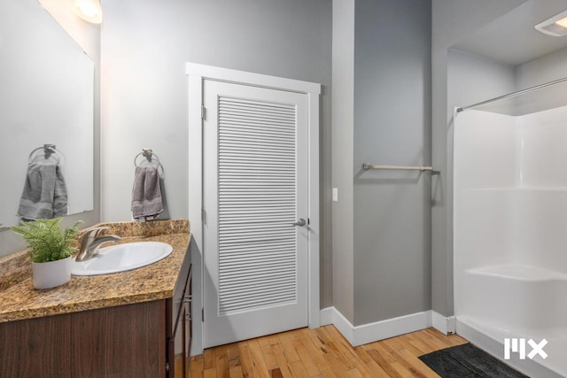 139 Pearl St NW, Grand Rapids, MI 49503 - bathroom with vanity, wood finished floors, and a shower