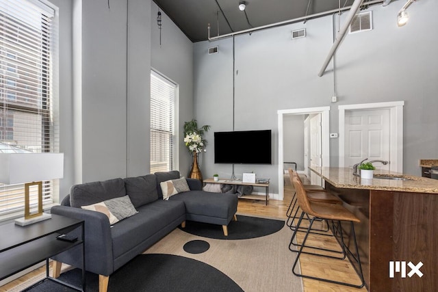 139 Pearl St NW, Grand Rapids, MI 49503 - living room featuring a high ceiling and light wood-style floors