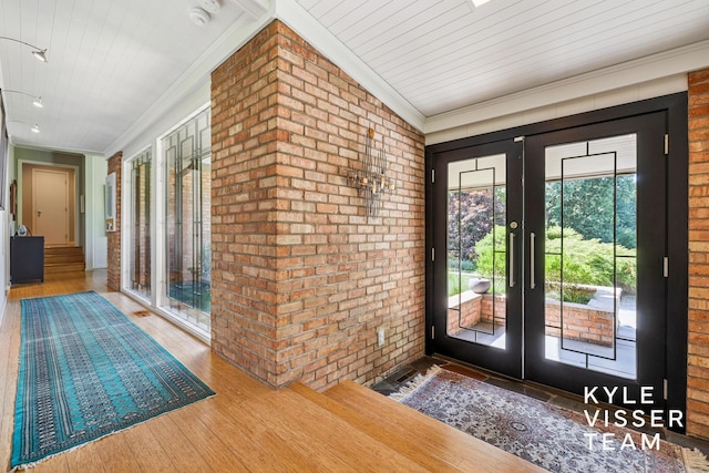 130 Robinwood Ave SE, Grand Rapids, MI 49506 - doorway with french doors, brick wall, wood finished floors, crown molding, and wood ceiling