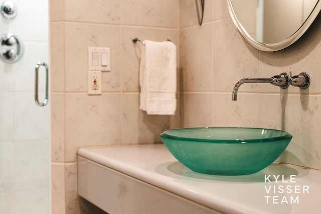 130 Robinwood Ave SE, Grand Rapids, MI 49506 - bathroom featuring tile walls, vanity, and a shower