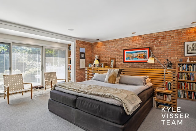 130 Robinwood Ave SE, Grand Rapids, MI 49506 - bedroom with carpet, brick wall, and access to exterior