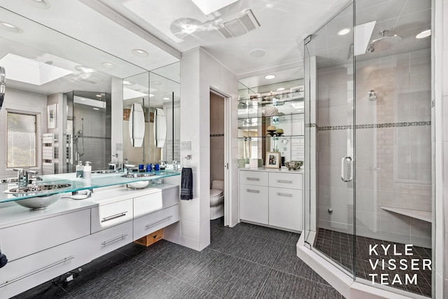 130 Robinwood Ave SE, Grand Rapids, MI 49506 - full bathroom featuring vanity, a stall shower, recessed lighting, and tile patterned flooring