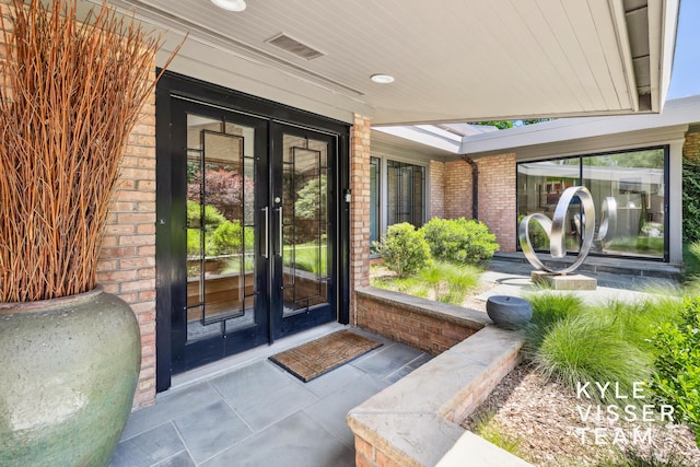 130 Robinwood Ave SE, Grand Rapids, MI 49506 - view of exterior entry with brick siding and french doors