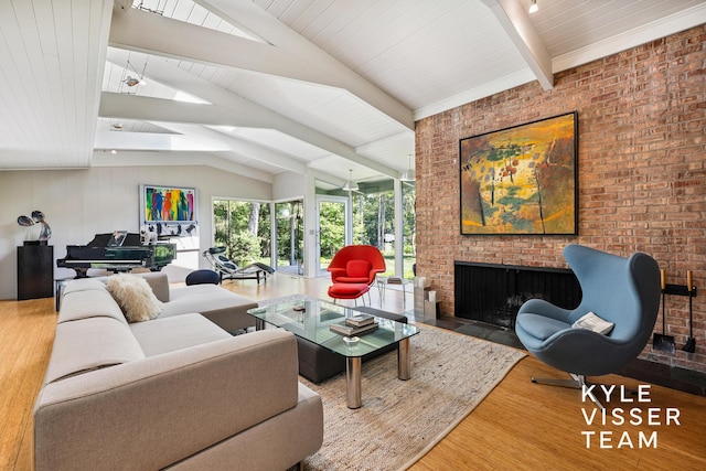 130 Robinwood Ave SE, Grand Rapids, MI 49506 - living area with wood finished floors, a fireplace, a skylight, and brick wall