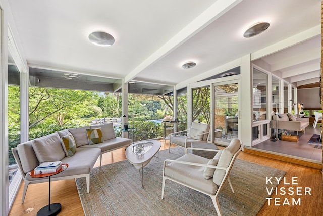130 Robinwood Ave SE, Grand Rapids, MI 49506 - sunroom featuring outdoor lounge area, wood finished floors, expansive windows, and beamed ceiling