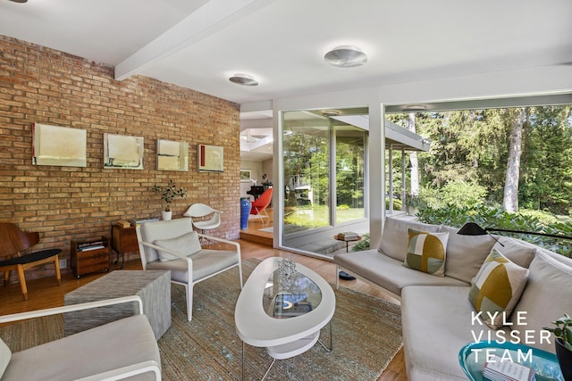 130 Robinwood Ave SE, Grand Rapids, MI 49506 - living room with wood finished floors, beam ceiling, and brick wall