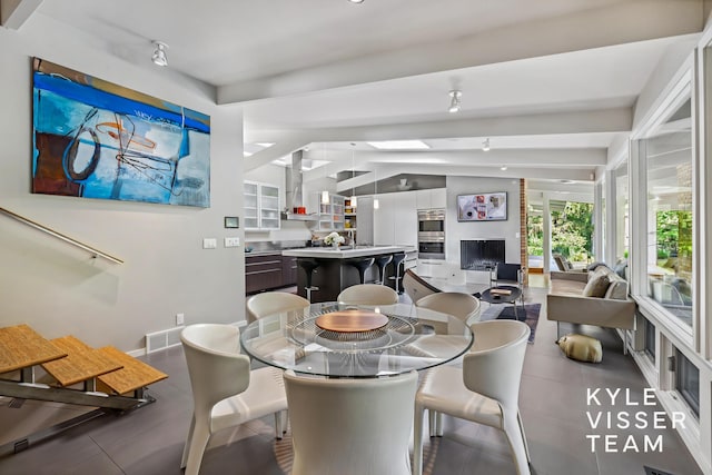 130 Robinwood Ave SE, Grand Rapids, MI 49506 - tiled dining room featuring track lighting and baseboards