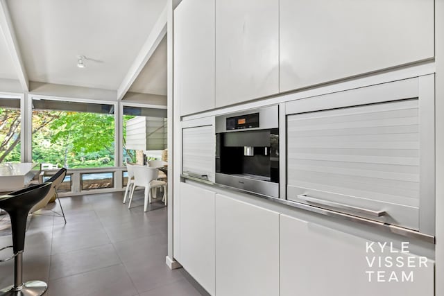 130 Robinwood Ave SE, Grand Rapids, MI 49506 - interior space featuring white cabinetry, modern cabinets, and dark tile patterned flooring