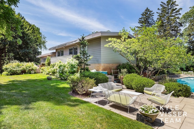 130 Robinwood Ave SE, Grand Rapids, MI 49506 - rear view of property featuring a patio area, brick siding, a yard, and an outdoor pool