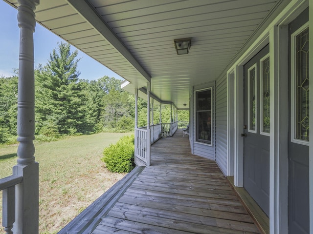 626 Skocelas Rd N, Manistee, MI 49660 - wooden terrace featuring a lawn