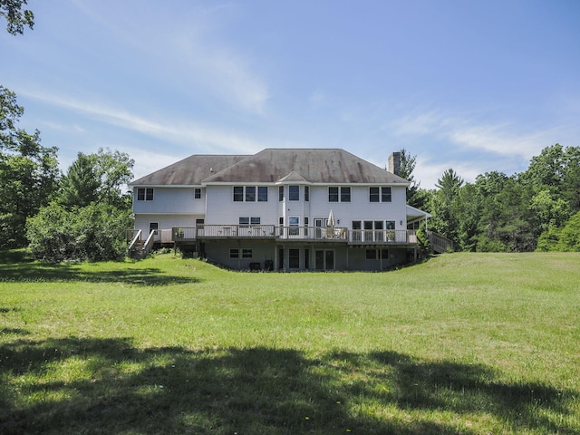 626 Skocelas Rd N, Manistee, MI 49660 - rear view of property featuring a chimney, a deck, and a lawn
