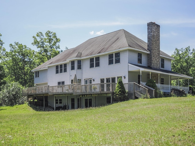 626 Skocelas Rd N, Manistee, MI 49660 - back of house featuring a chimney, a lawn, and a deck