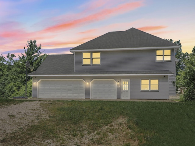 626 Skocelas Rd N, Manistee, MI 49660 - view of front of house with driveway, a front lawn, and a garage