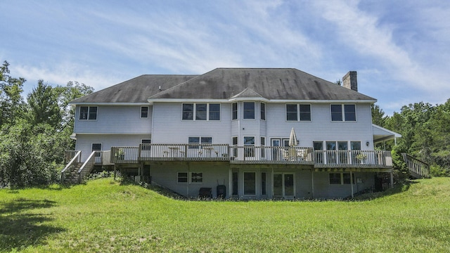 626 Skocelas Rd N, Manistee, MI 49660 - rear view of house with stairs, a chimney, a yard, and a deck