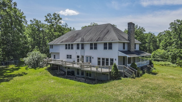 626 Skocelas Rd N, Manistee, MI 49660 - back of property featuring a chimney, a yard, a deck, and stairs