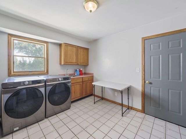 626 Skocelas Rd N, Manistee, MI 49660 - laundry room featuring washing machine and dryer and cabinet space