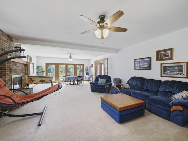 626 Skocelas Rd N, Manistee, MI 49660 - living area featuring carpet floors, a fireplace, and ceiling fan