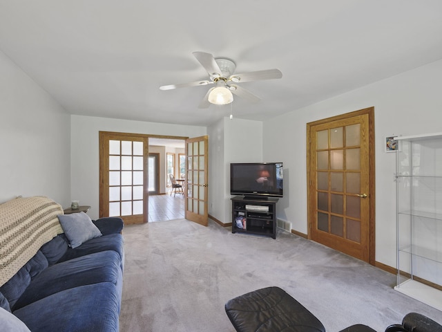 626 Skocelas Rd N, Manistee, MI 49660 - living room featuring french doors, carpet flooring, and a ceiling fan