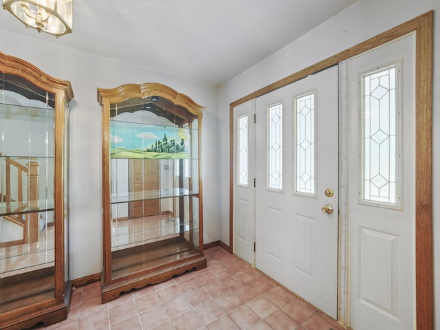 626 Skocelas Rd N, Manistee, MI 49660 - foyer featuring baseboards and light tile patterned flooring