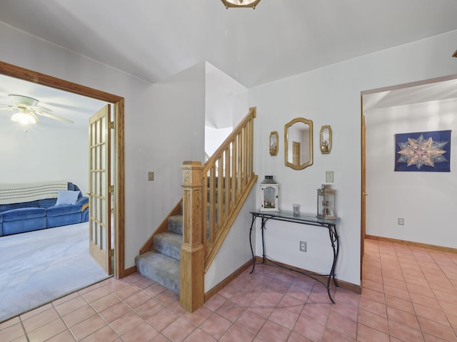 626 Skocelas Rd N, Manistee, MI 49660 - staircase featuring ceiling fan and tile patterned floors