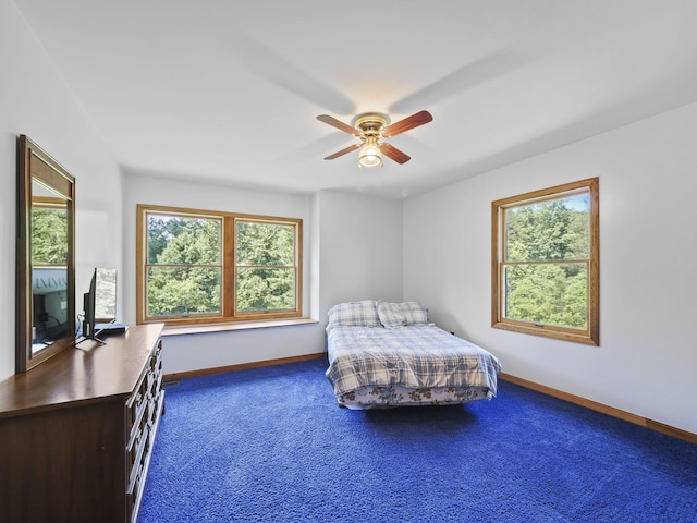 626 Skocelas Rd N, Manistee, MI 49660 - bedroom with carpet, multiple windows, and ceiling fan