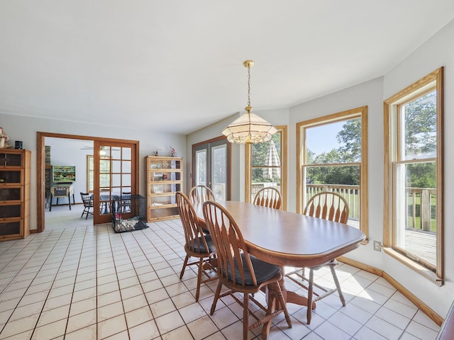 626 Skocelas Rd N, Manistee, MI 49660 - dining area featuring a chandelier, healthy amount of natural light, french doors, and light tile patterned flooring
