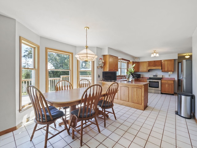 626 Skocelas Rd N, Manistee, MI 49660 - dining space with healthy amount of natural light, light tile patterned floors, and a chandelier