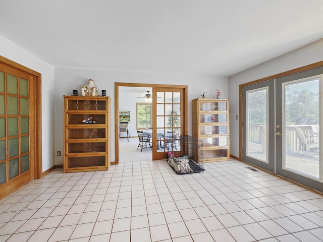 626 Skocelas Rd N, Manistee, MI 49660 - sitting room with french doors, ceiling fan, and light tile patterned floors