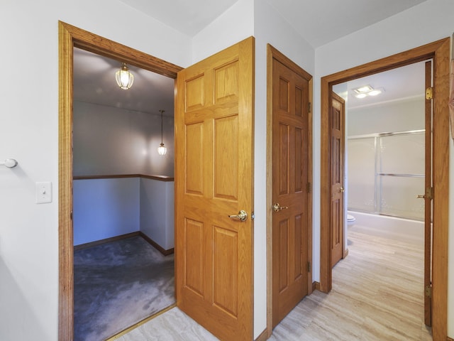 626 Skocelas Rd N, Manistee, MI 49660 - hallway with baseboards and wood finished floors