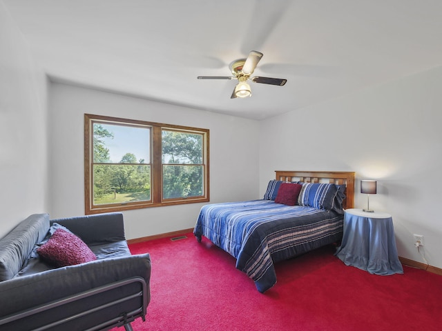 626 Skocelas Rd N, Manistee, MI 49660 - carpeted bedroom with baseboards and ceiling fan