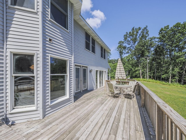 626 Skocelas Rd N, Manistee, MI 49660 - wooden deck with outdoor dining area and a yard