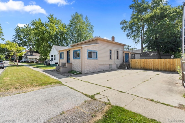 128 N Mary St, Marine City, MI 48039 - view of front of house featuring entry steps, a chimney, stone siding, and concrete driveway