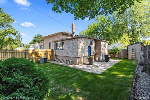 128 N Mary St, Marine City, MI 48039 - rear view of property with stone siding, a fenced backyard, a chimney, and an outdoor structure