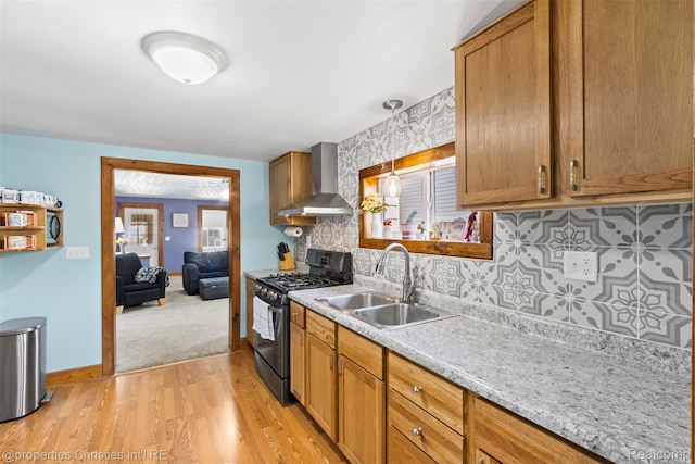 128 N Mary St, Marine City, MI 48039 - kitchen with wall chimney exhaust hood, black gas range, light wood-type flooring, light countertops, and tasteful backsplash