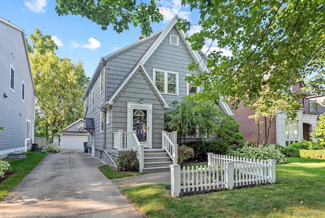 532 Wallace St, Southfield, MI 48009 - view of front facade featuring an outbuilding, a detached garage, and a chimney