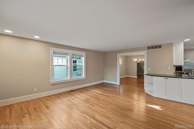 532 Wallace St, Southfield, MI 48009 - unfurnished living room with a chandelier, light wood-style flooring, and recessed lighting