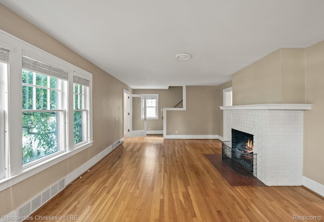532 Wallace St, Southfield, MI 48009 - unfurnished living room featuring light wood-style flooring and a fireplace