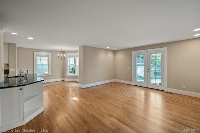 532 Wallace St, Southfield, MI 48009 - unfurnished living room with a chandelier, light wood-style floors, recessed lighting, and french doors