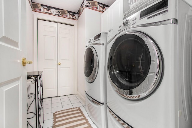 4202 Courtney St, Saint Joseph, MI 49085 - laundry room with cabinet space, washing machine and clothes dryer, and light tile patterned floors