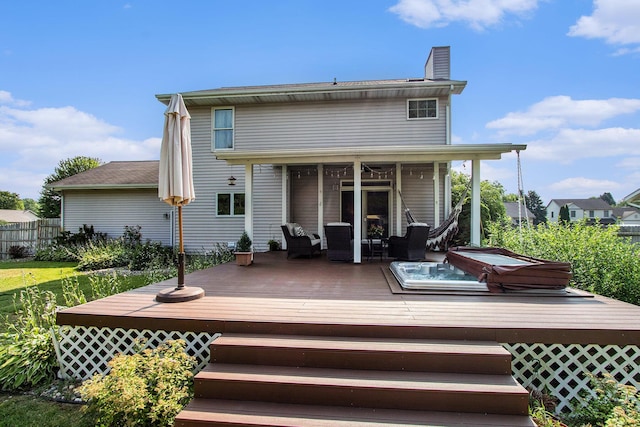 4202 Courtney St, Saint Joseph, MI 49085 - back of house featuring a deck, a chimney, and a covered hot tub